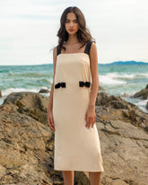 Sleeveless silk midi dress with contrast straps and back bow detail for elegant styling